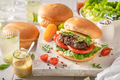 Tasty grilled hamburger served with lemonade and mustard. - PhotoDune Item for Sale