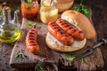 Hot grilled sausage with bun and mustard and ketchup. - PhotoDune Item for Sale