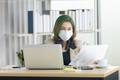 Business woman wearing face mask and using partition on table  - PhotoDune Item for Sale