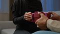 Unknown man congratulate beloved woman give surprise pink box with ribbon indoors female hands - PhotoDune Item for Sale
