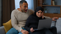 Married ethnic couple husband and wife African american man use laptop with arabian muslim woman at - PhotoDune Item for Sale