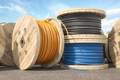 Wire electric cable of different colors on wooden coil or spool in warehouse. - PhotoDune Item for Sale
