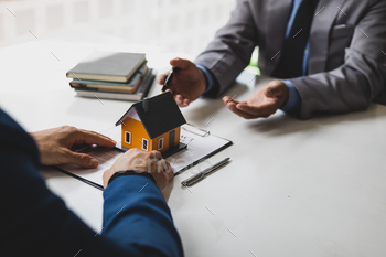 terms of the home purchase contract. Businessman signing a contract agreement, mortgage, rent, lease, home insurance.