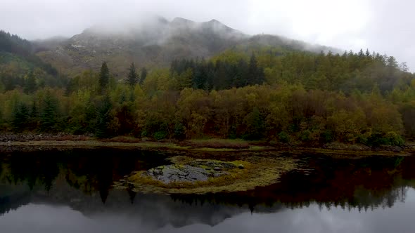 Aerial drone view of Loch Leven in Scotland on a moody misty day