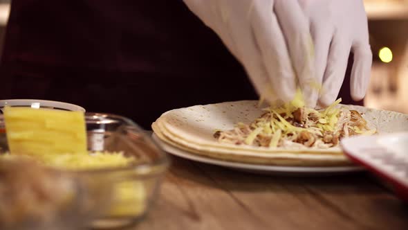 Closeup Footage of Preparing Traditional Mexican Enchilada From Tortilla with Chicken and Cheese