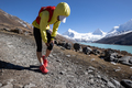Woman runner with sports injured knee running at high altitude mountain trail - PhotoDune Item for Sale