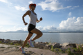 Fitness woman running on sunny tropical seaside - PhotoDune Item for Sale