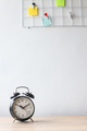 Black alarm clock on wooden desk at the office - PhotoDune Item for Sale