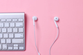 White computer keyboard and earphones on pink theme - PhotoDune Item for Sale