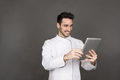Smiling young male chef using tablet in studio - PhotoDune Item for Sale