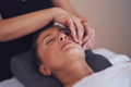 Woman having japan style face massage in salon - PhotoDune Item for Sale