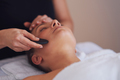Brunette woman having a stone massage on face - PhotoDune Item for Sale
