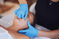 Woman having mouth massage in blue gloves - PhotoDune Item for Sale
