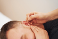 A picture of a man having acupuncture on ear - PhotoDune Item for Sale
