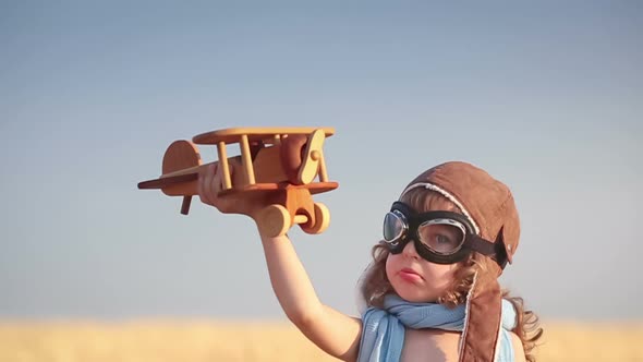 Happy Kid Playing with Toy Airplane