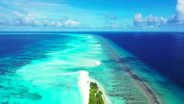 Daytime birds eye clean view of a summer white paradise sand beach and aqua blue ocean background in