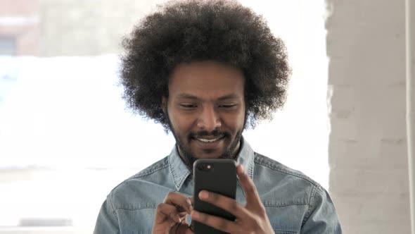 African Man Using Smartphone, Text Messaging