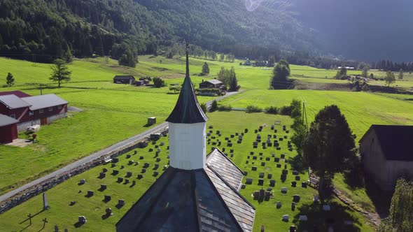 Loen church at sunrise - Morning reverse aerial from church tower and back - Revealing countryside f