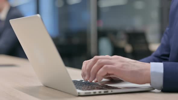 Hand Close Up of Businessman Working on Laptop