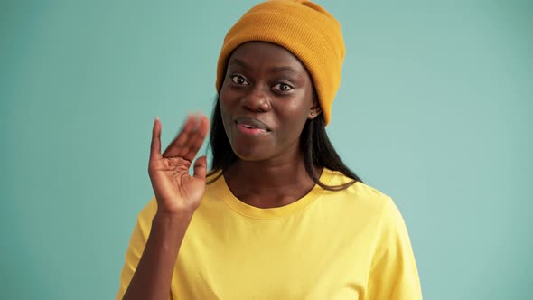 Cheerful African woman greeting at the camera