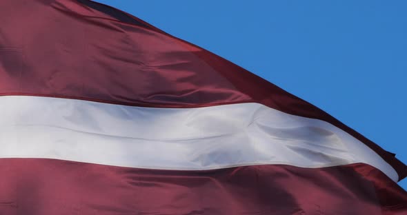 The national latvian flag waving in the wind.
