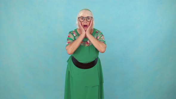 Surprised Shocked Elderly Woman on Blue Background