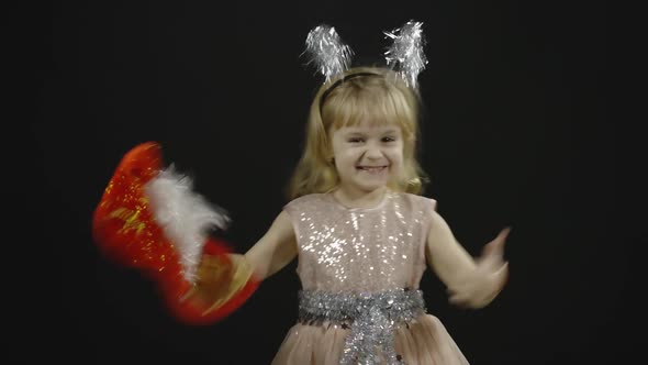 Happy Beautiful Little Baby Girl in Glossy Dress. Christmas. Make Faces, Dance