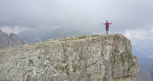 Aerial drone view of a man hiking in the mountains