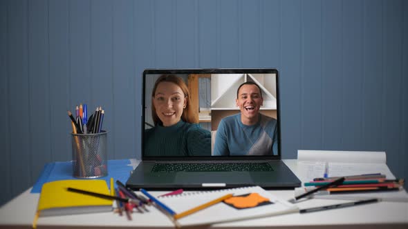 A Young Woman is Talking on a Video Call with a Young Man