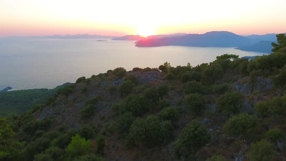 Morning Sunrise Over Forested Hills on the Seashore