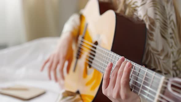 Slowmo of Happy Girl Playing Guitar and Singing in Morning
