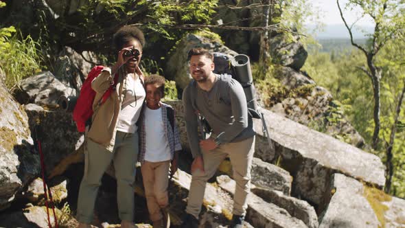 Multiethnic Family Looking though Binocular during Hike