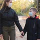 Woman and Her Son at an Empty Autumn Park Wearing Face Masks for Protection Against Virus - VideoHive Item for Sale