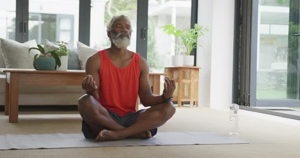 Video of african american senior man meditating