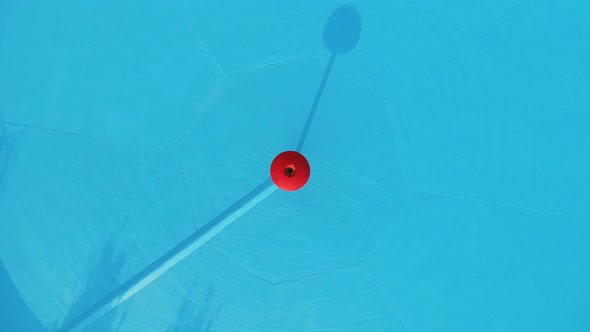 Aerial view of empty pool with blue background.