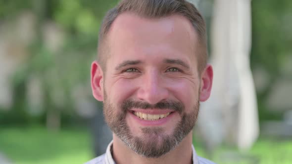 Close Up of Face of Middle Aged Man with Smiling Expression