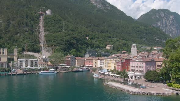 Drone flying towords the plaza in the center of the north italian city Riva Del Garda with the lake