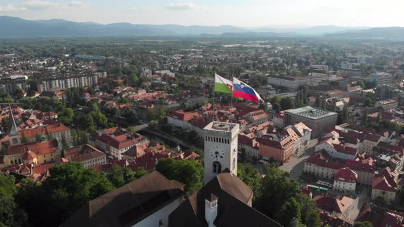 Drone flying above the Ljubljana castle with a view of the city and buildings near by