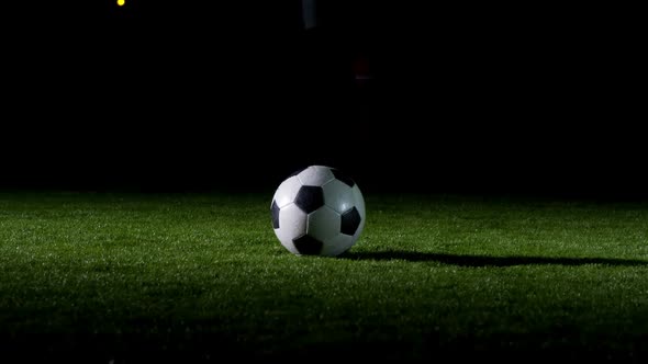 Soccer player performing a sliding tackle on playing field