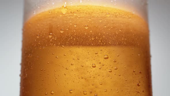 Extreme close-up beer in glass. Slow Motion.