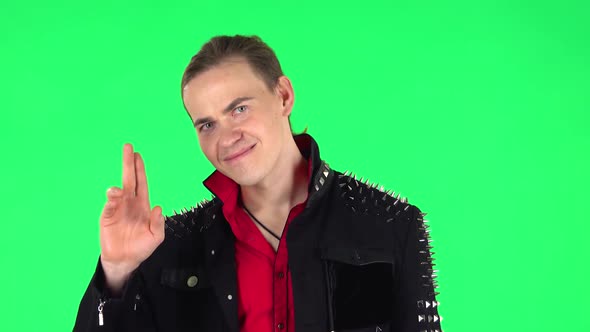 Guy Coquettishly Smiling, Waving Hand and Showing Gesture Come Here. Green Screen