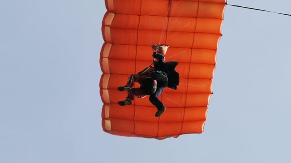Parachutists in Tandem Flying in the Sky with a Parachute