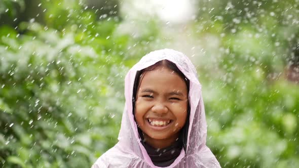 Happy girl wears raincoat