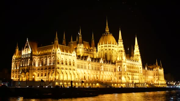 Girl photographing Budapest night parliament