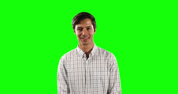 Front view of Caucasian man looking at camera with green screen