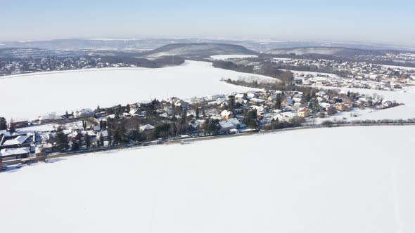 Aerial Drone Shot  Snowcovered Villages Fields and Forests in a Rural Area in Winter