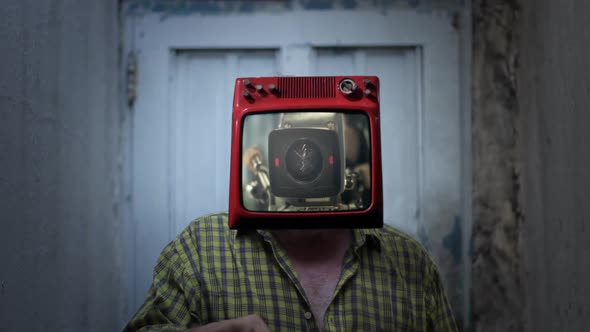 TV headed Man standing with a Television Camera on the Screen.