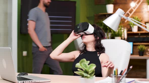 In Busy Office Girl Uses a VR Headset