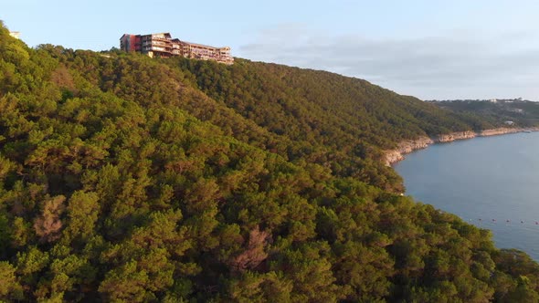 Slow Decending shot of the cliffs of Lake Travis with the Oasis in the background. Shot during golde