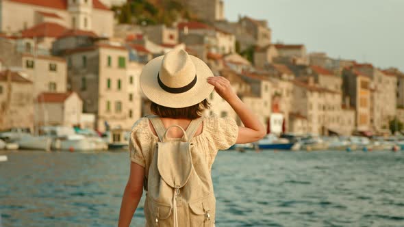 Happy woman looking at the sea on vacation